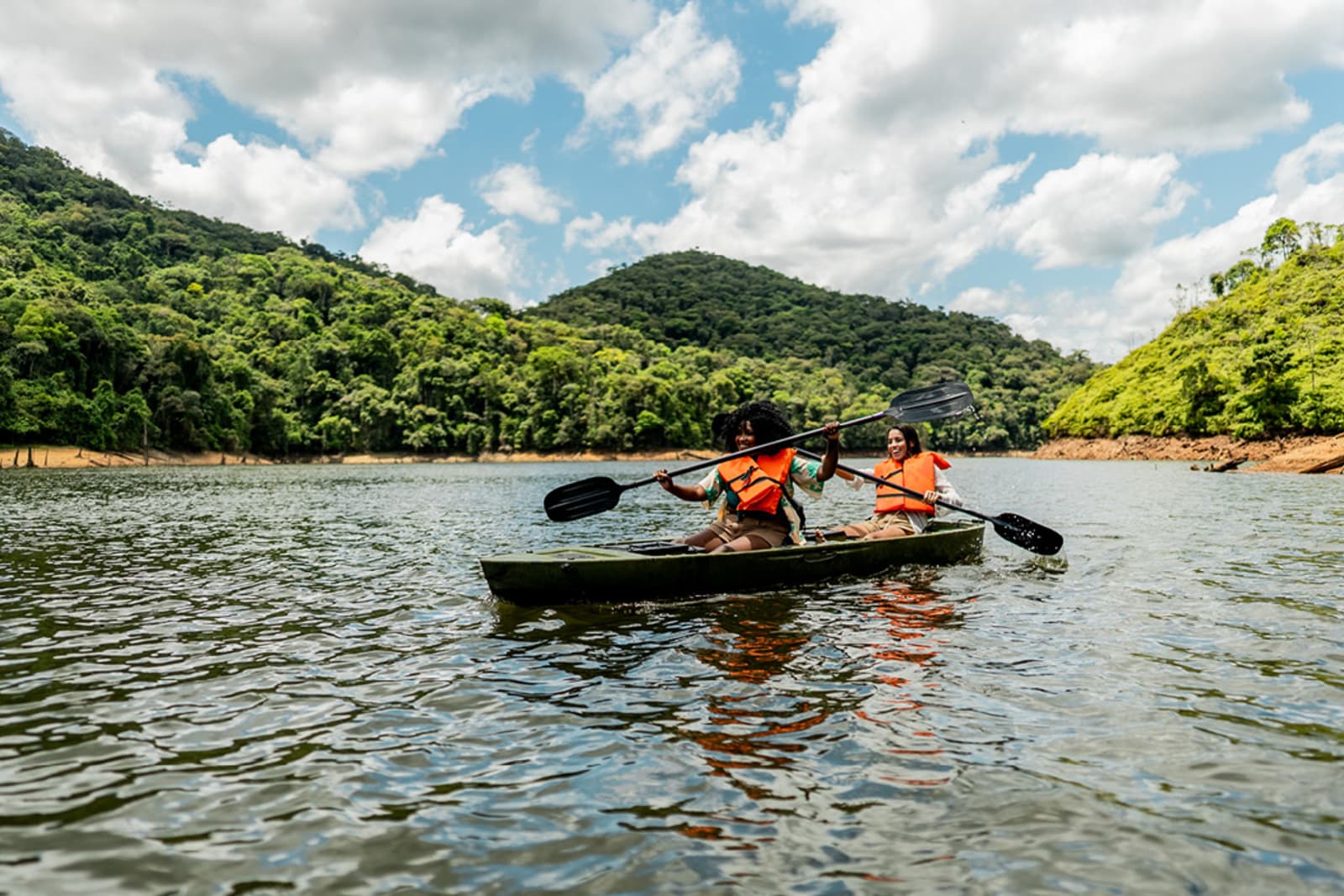 Travellers paddling on a river in Brazil