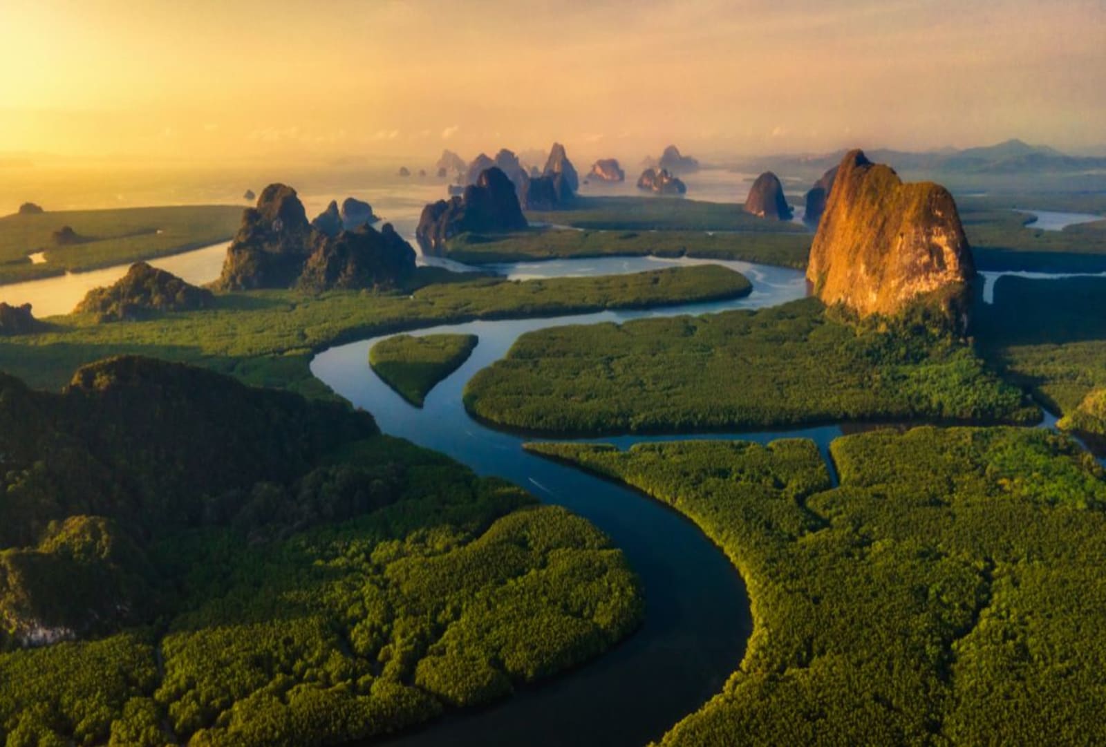 An image of the sun rising over Phang-Nga Bay in Thailand
