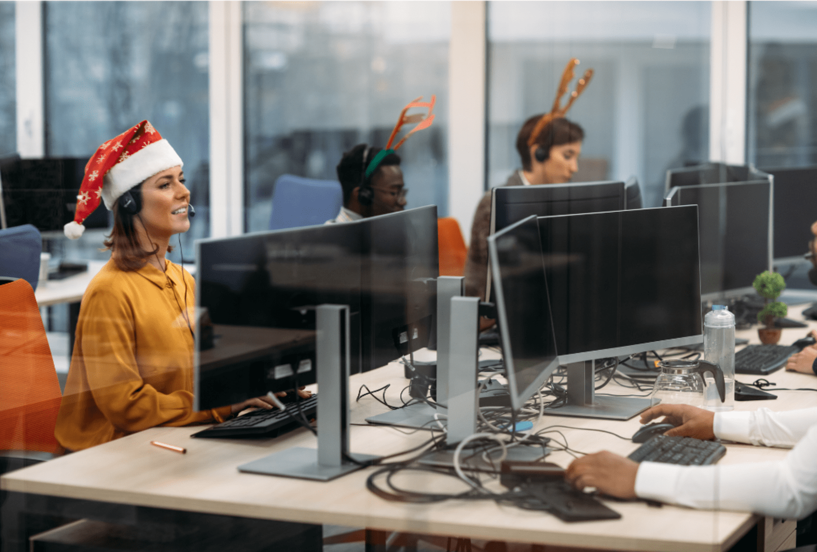 Call centre staff wear Santa hats and reindeer antlers as they work through Christmas