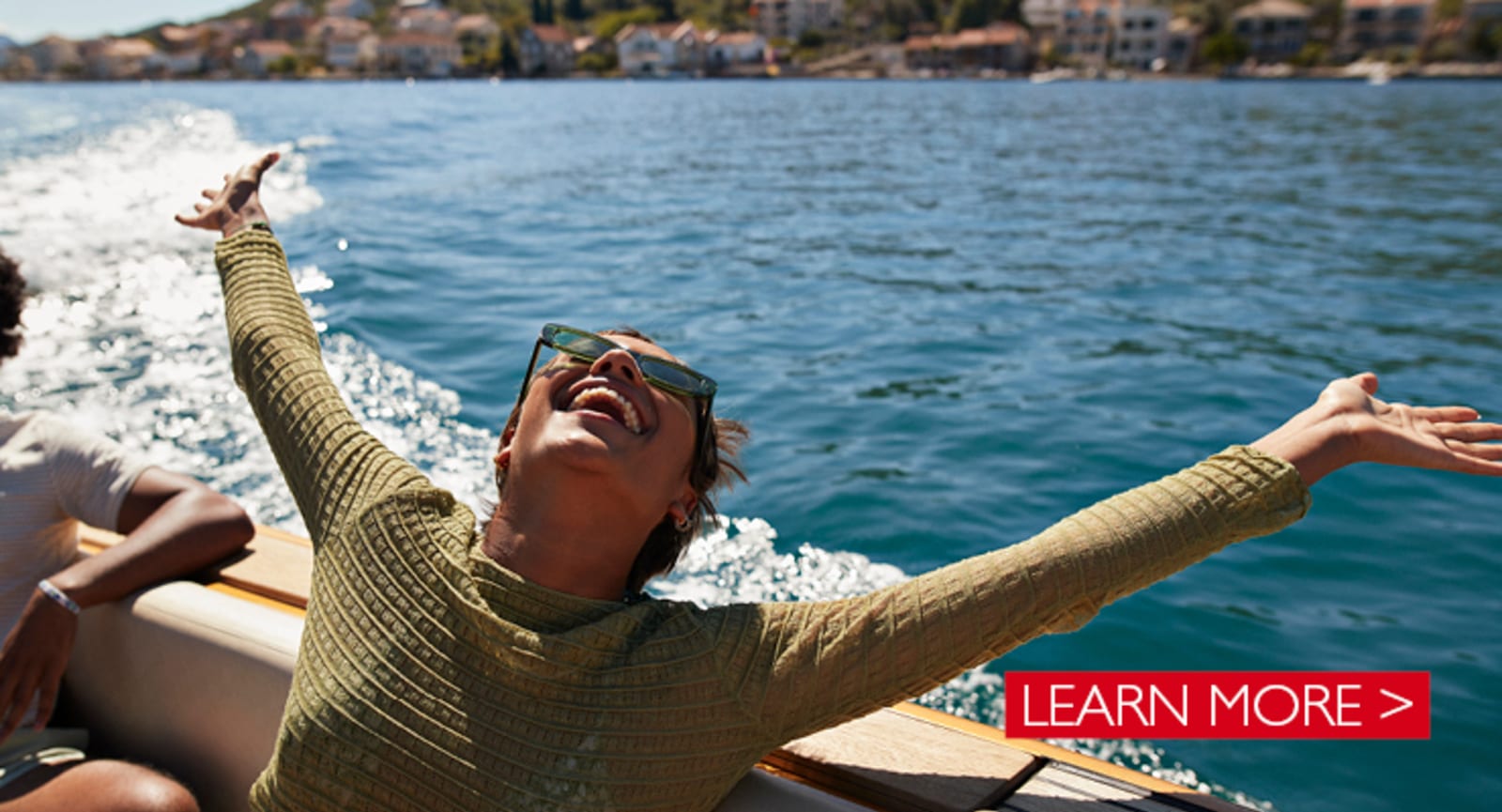 Black woman cheering on the edge of a boat on a river