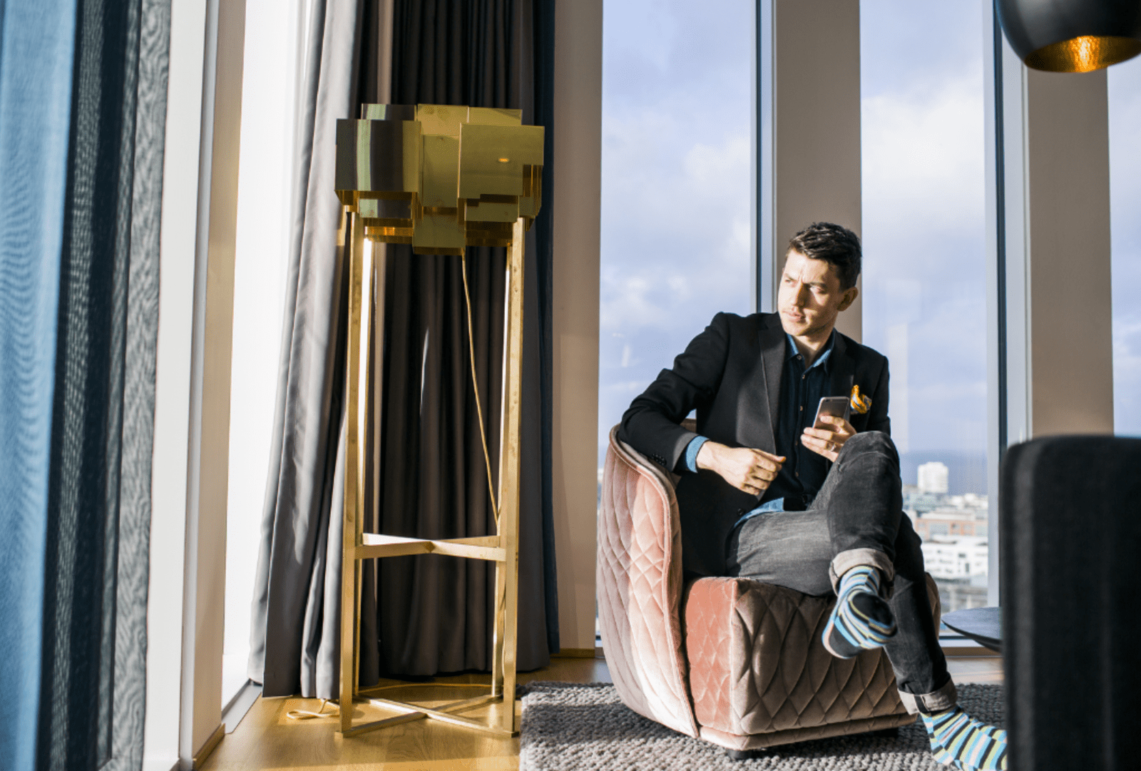 Businessman sitting in a chair relaxing in a hotel room