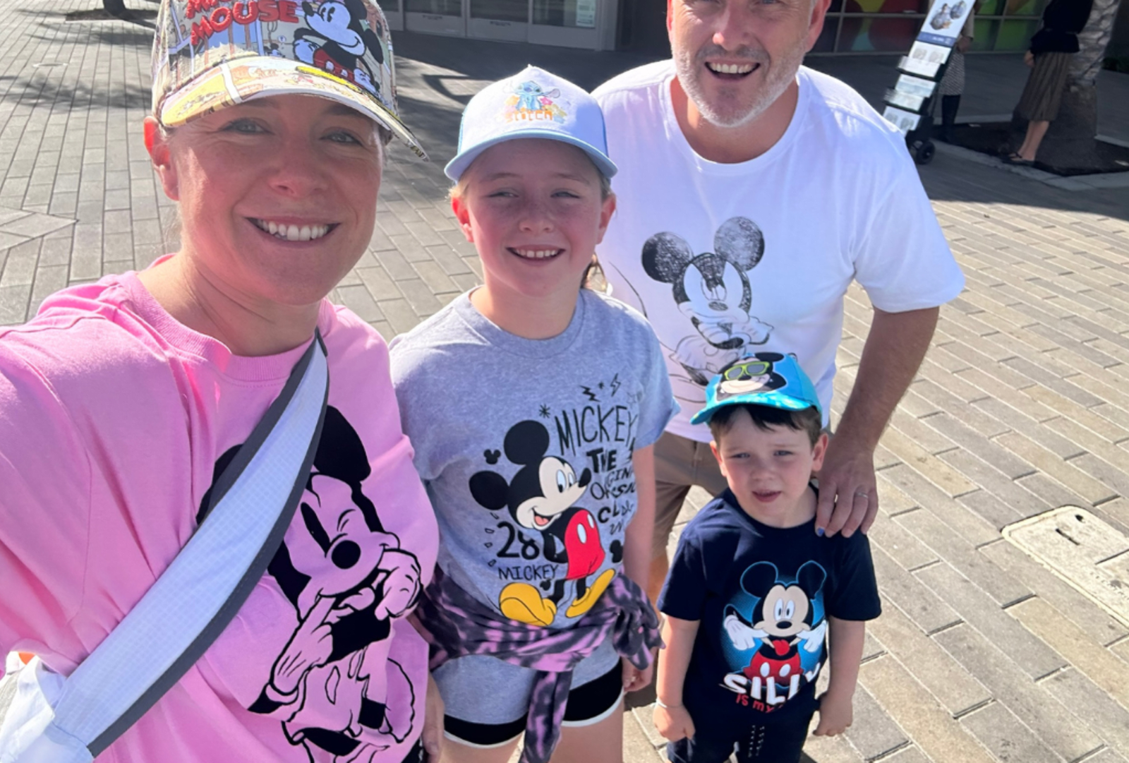 A family visiting Disneyland wearing Mickey Mouse T-shirts