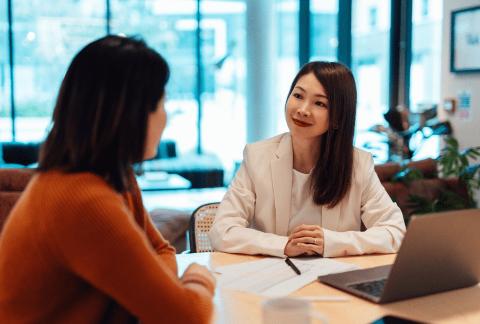 A client facing conversation between two women in a business setting