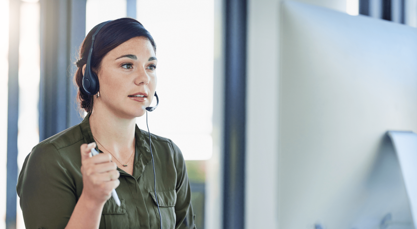 A woman wearing a headset talks with a customer