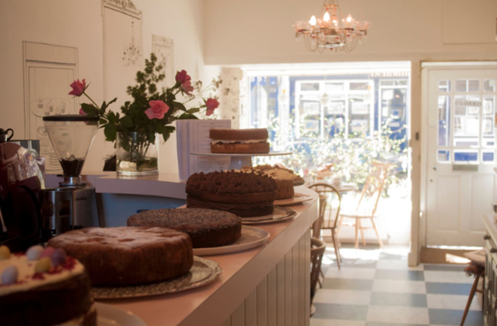 Chocolate cakes lined up on a table in a fancy bakery