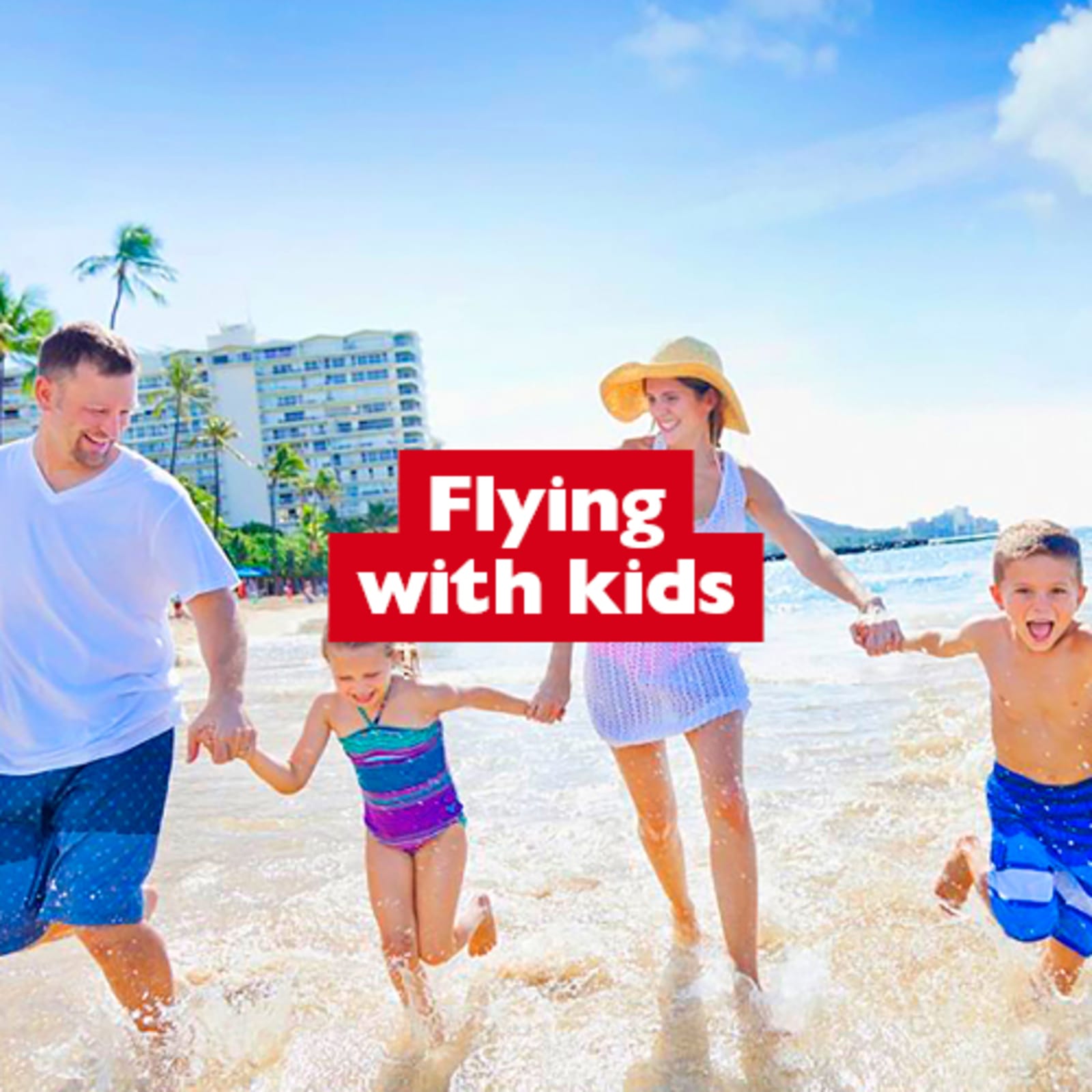 Flying with kids - family of four walking along a beach