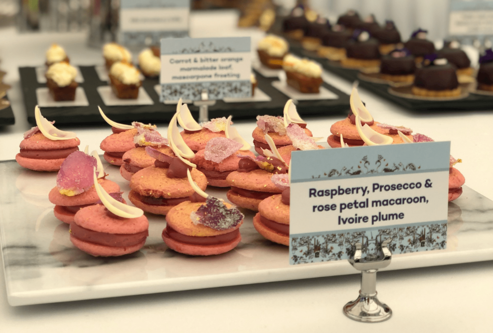 Ornate macaroons served on a marble plate