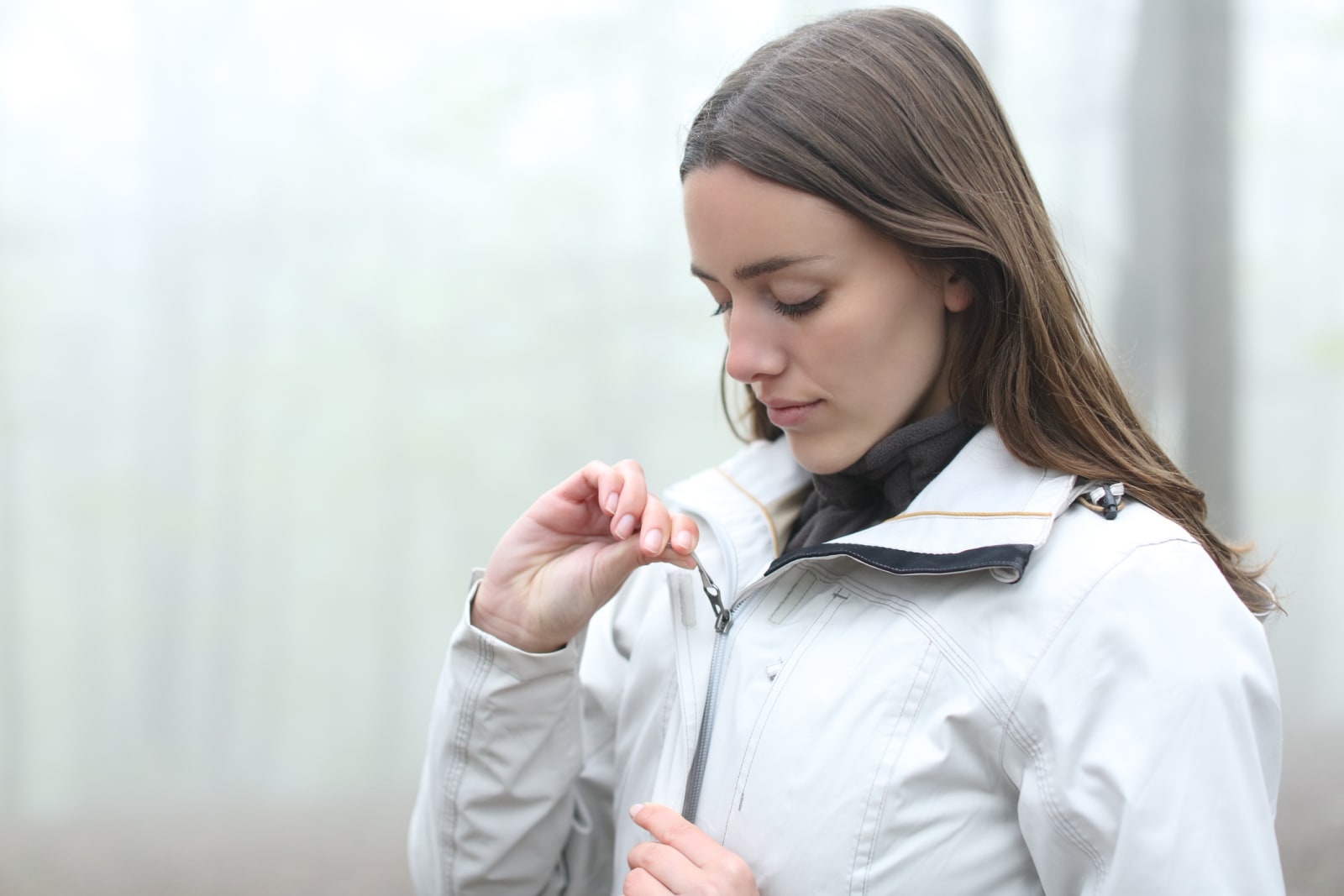Woman zipping up hiking jacket