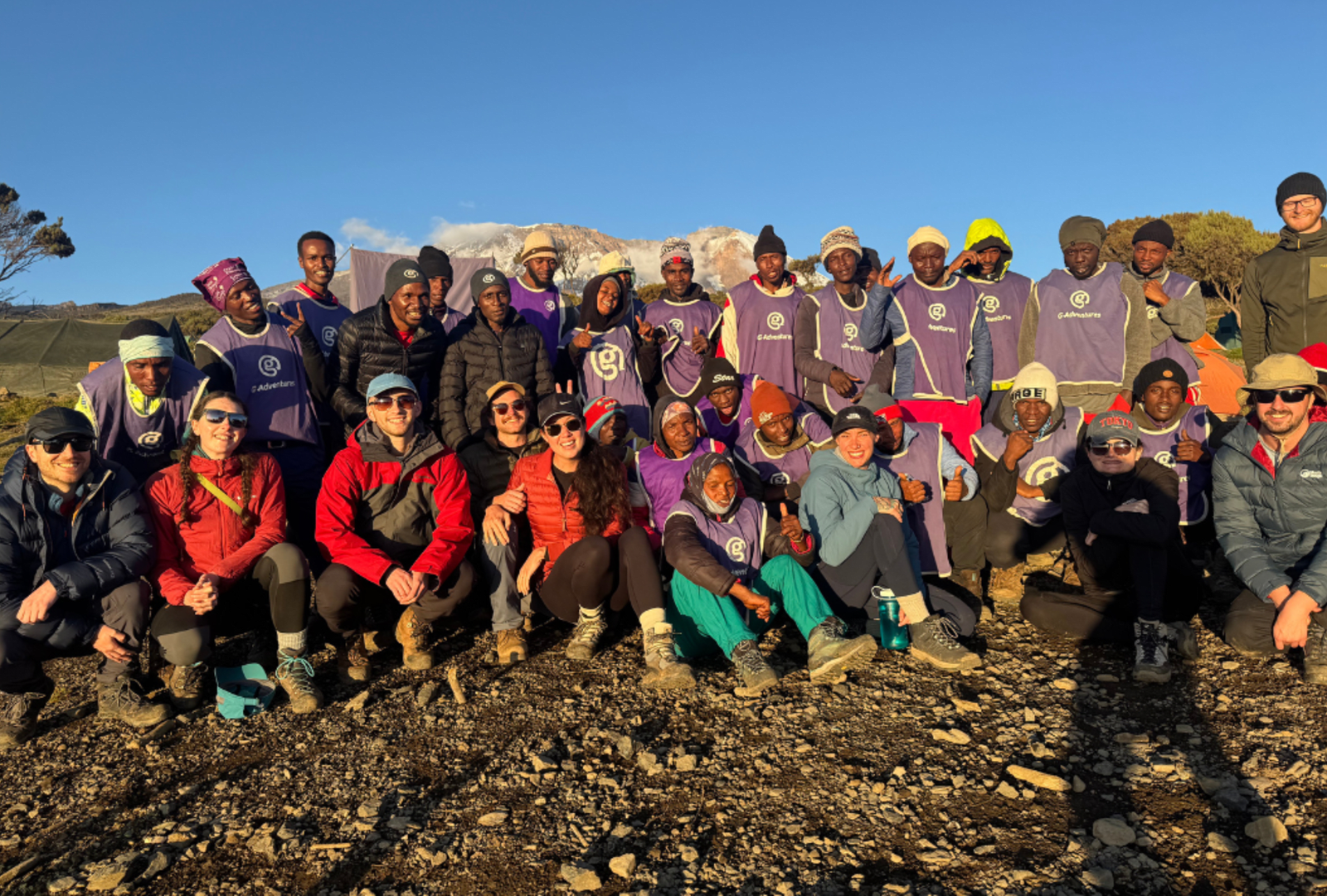 A hiking group and expedition staff gather for a photo