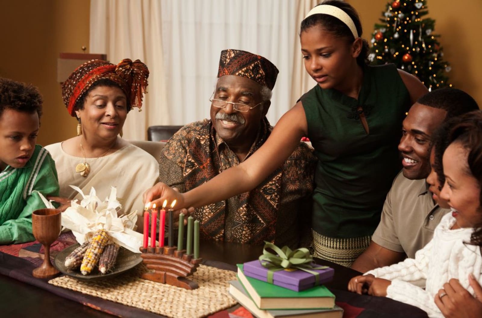 A family lighting the kinara in celebration of Kwanzaa