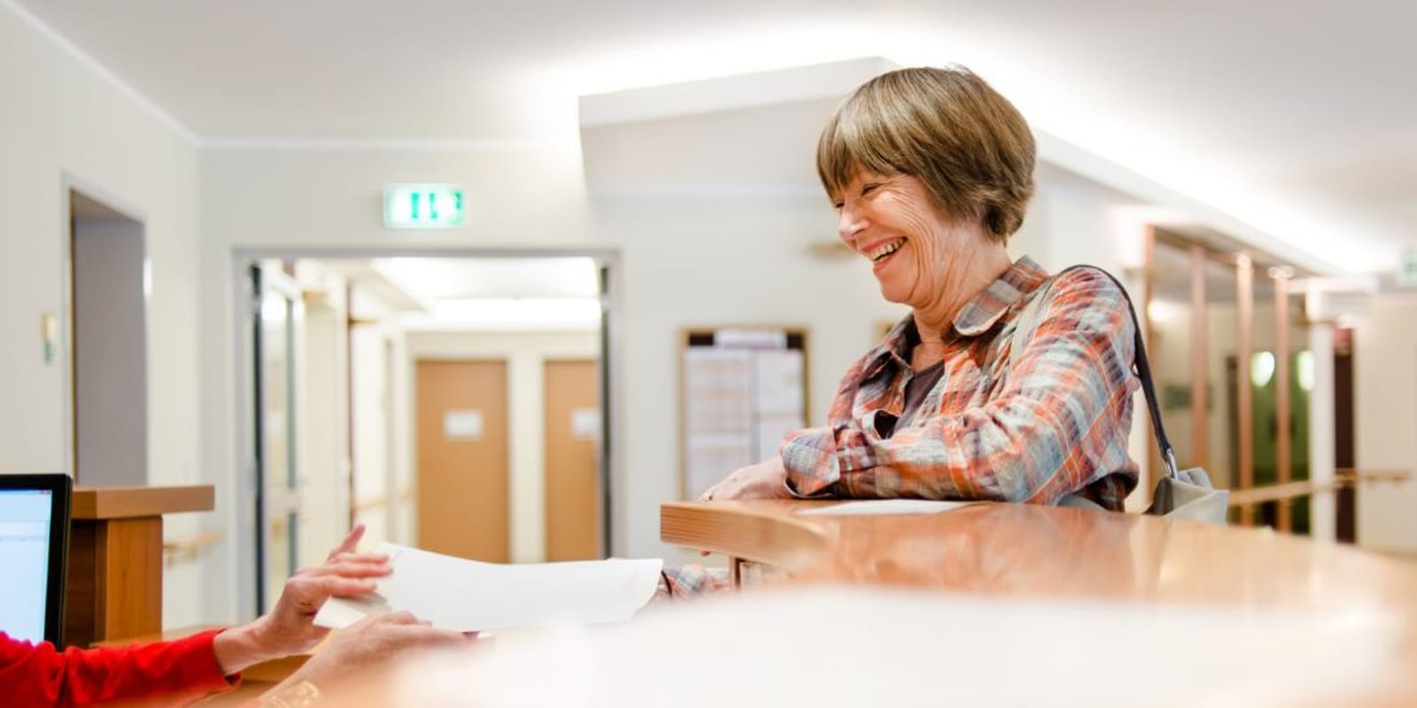 A friendly person talking to hotel reception
