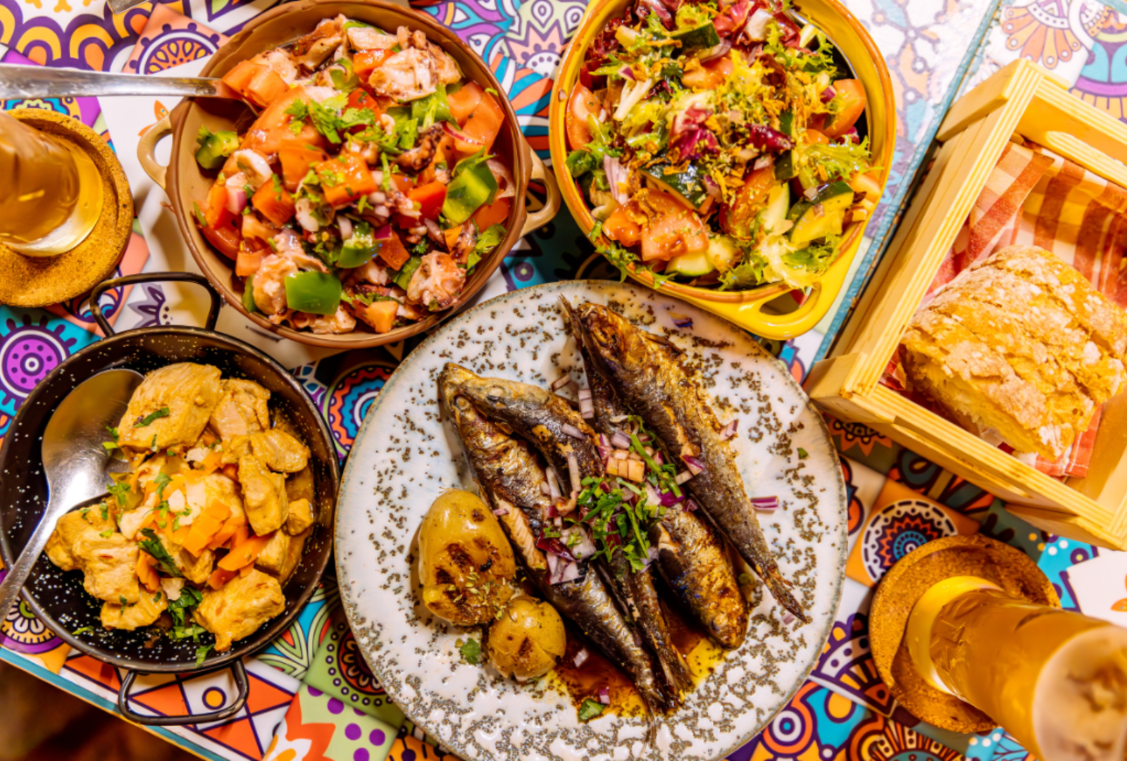 Traditional Portuguese dinner with griller sardines and octopus salad