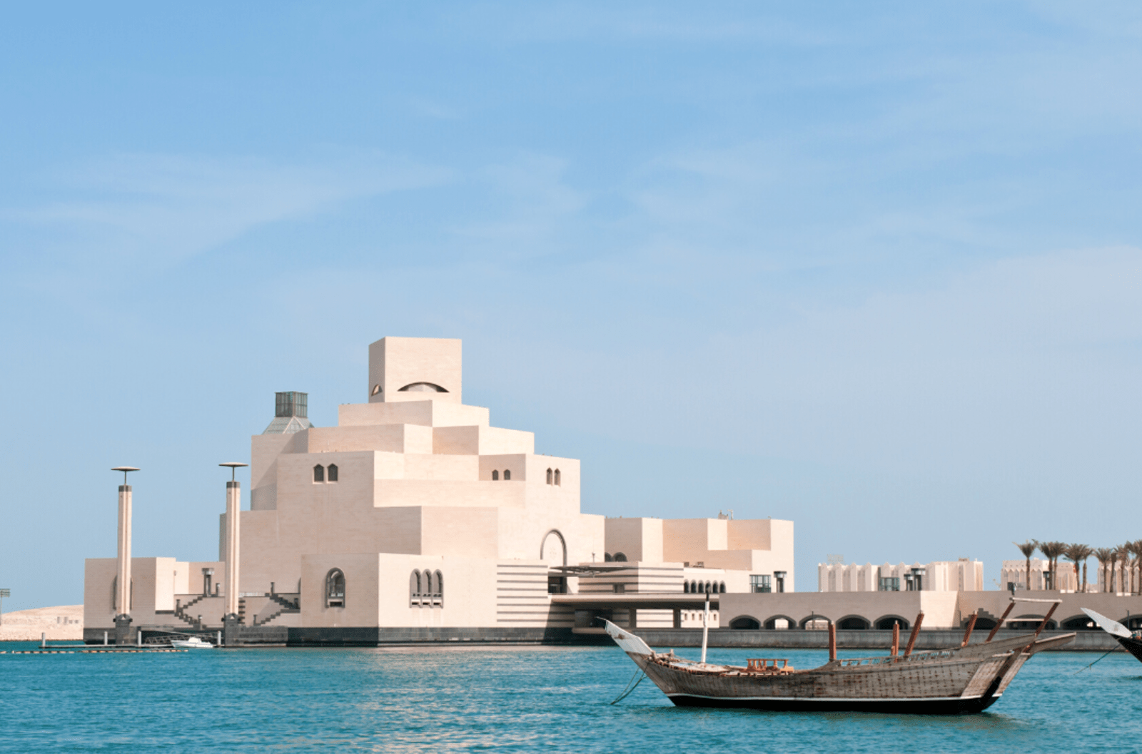 Unique architecture of the Museum of Islamic Art and a boat on Doha's waterfront