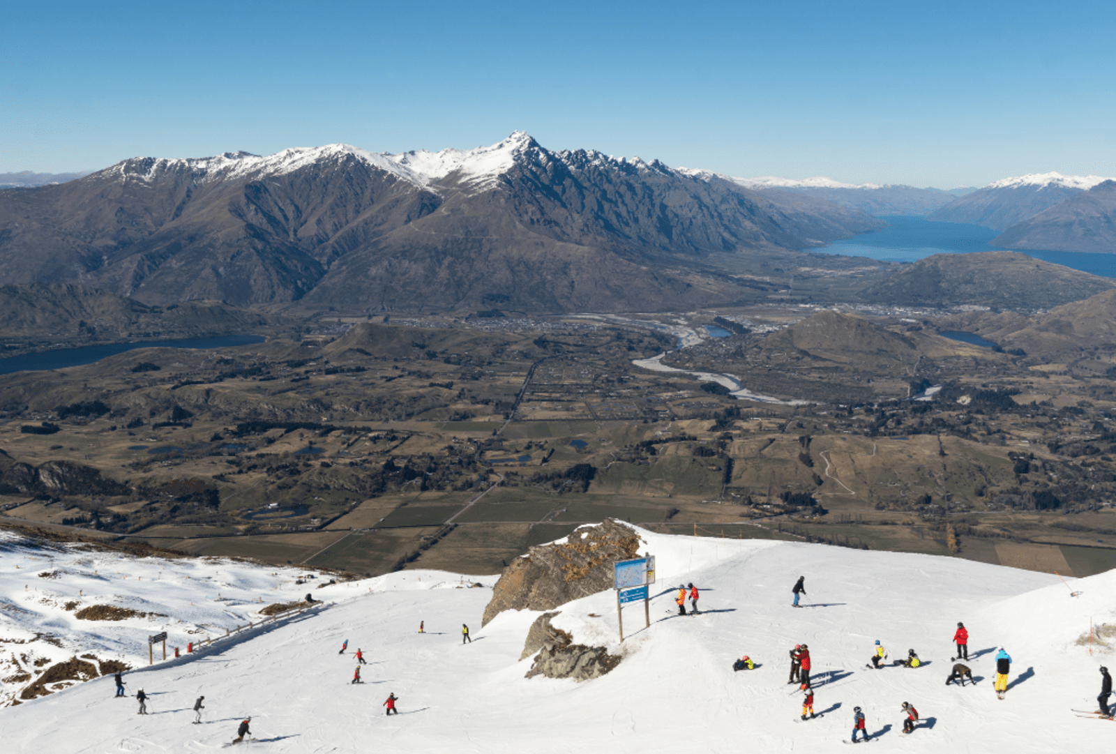 Skiers on the slope of the Coronet Peak ski resort near Queenstown in New Zealand