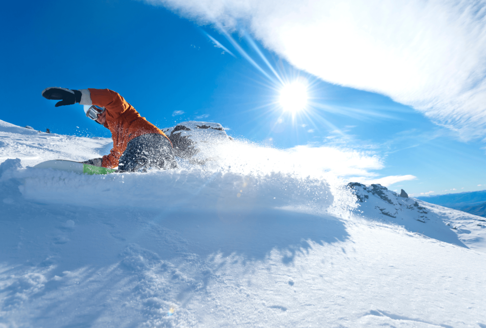 A snowboarder carves up the fresh snow of Cardrona ski field