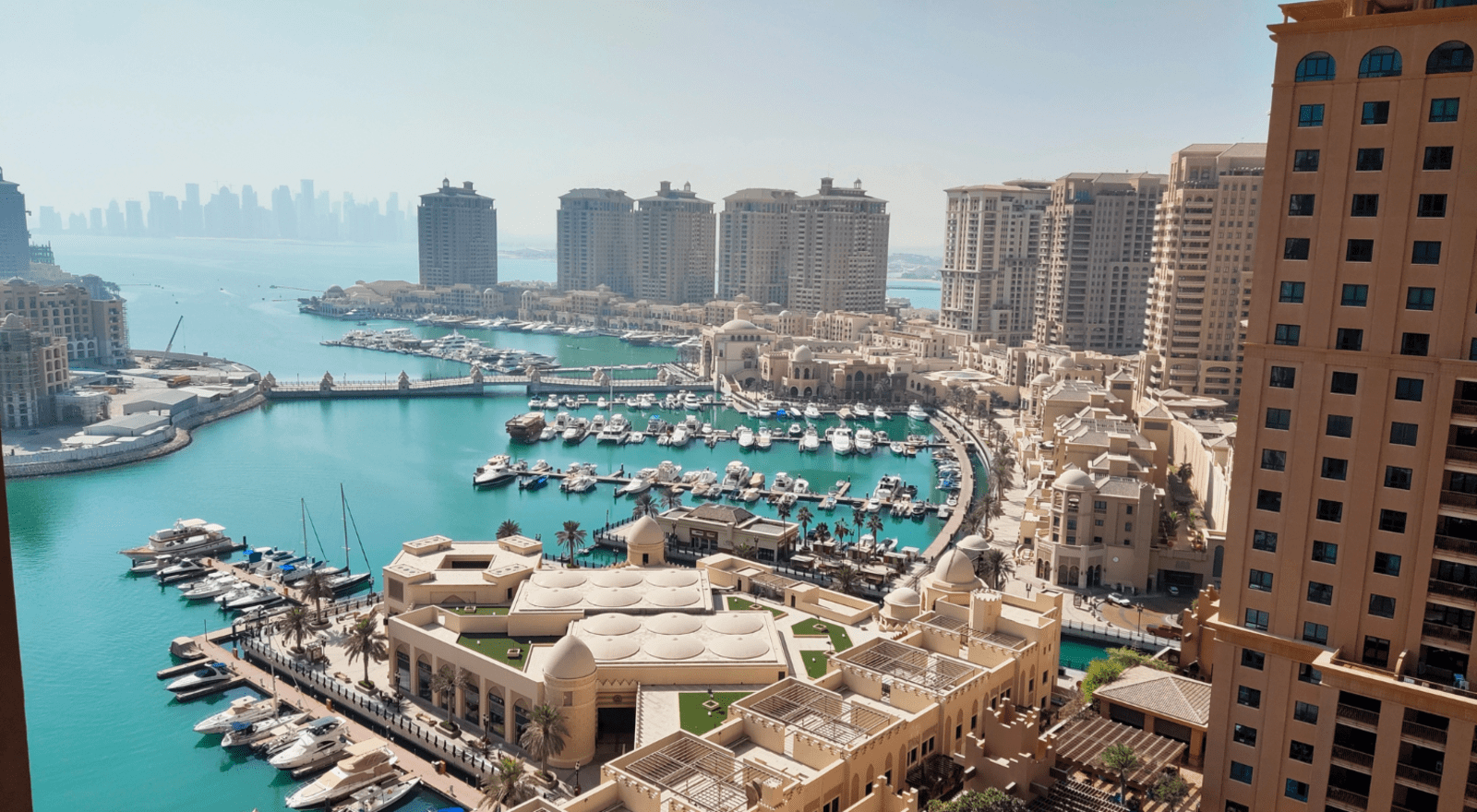 High angle view of buildings by sea against sky, Doha, Qatar.