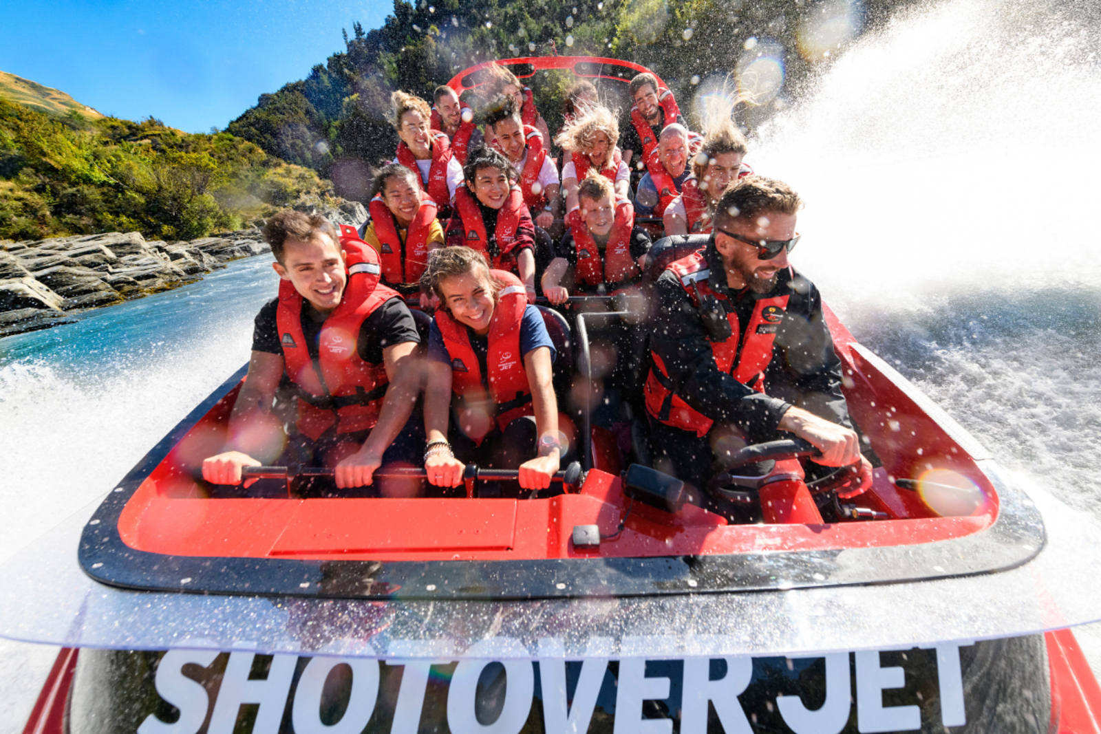 Passengers on the Shotover River jetboat get sprayed with water, Queenstown NZ.