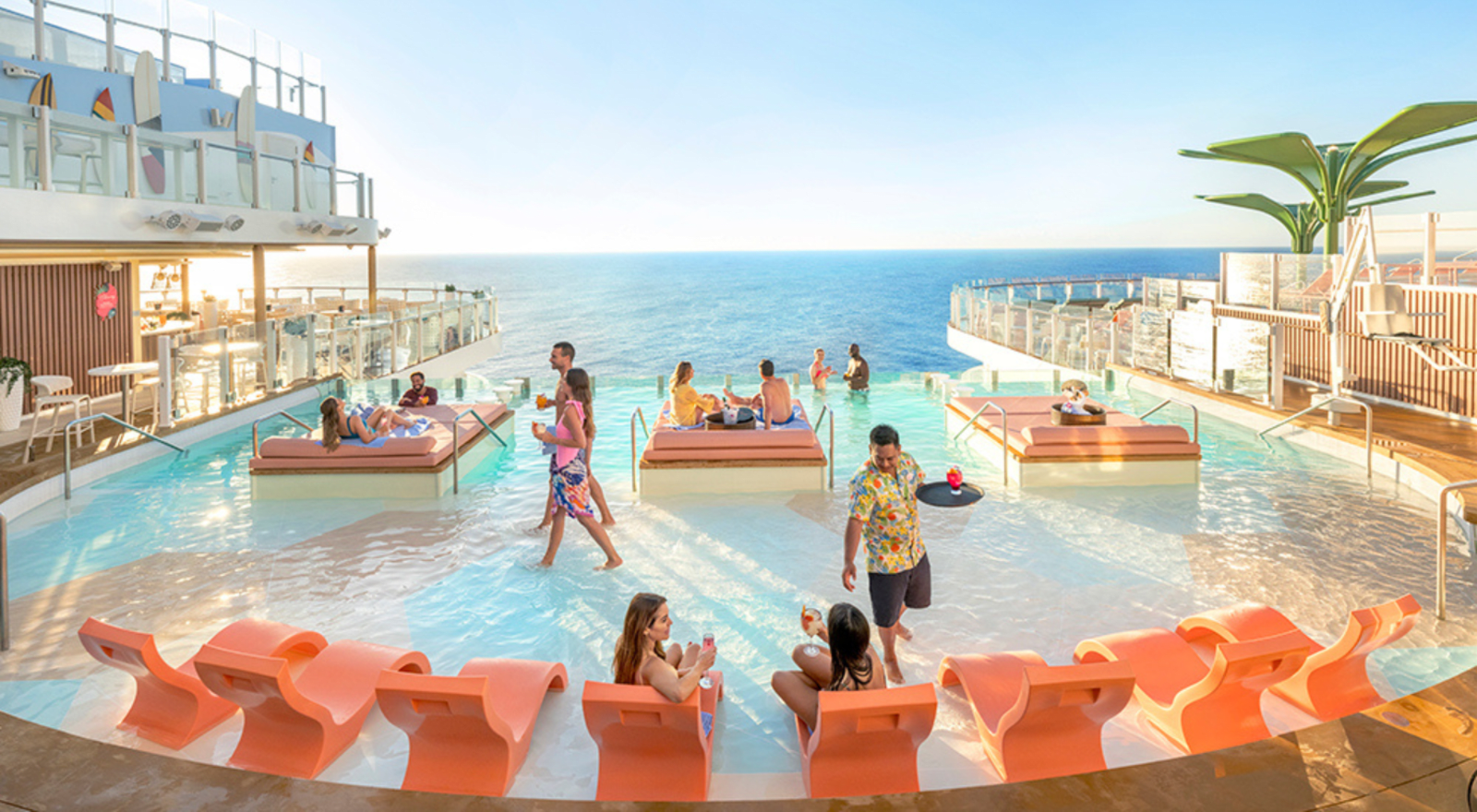 People relax by the pool on a cruise ship deck with ocean views