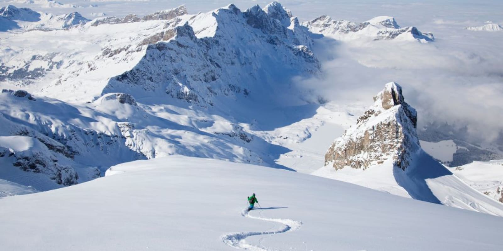 A person skiing down a mountain in Switzerland