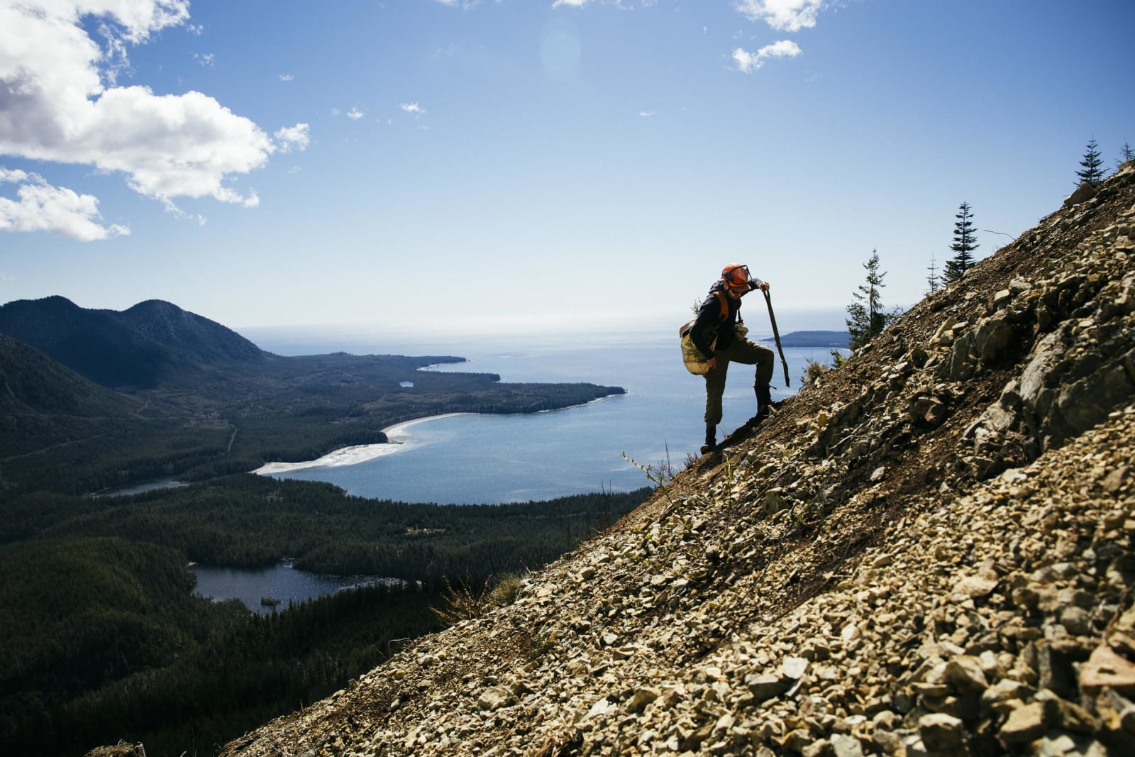 Man digging on the slope of a mountain