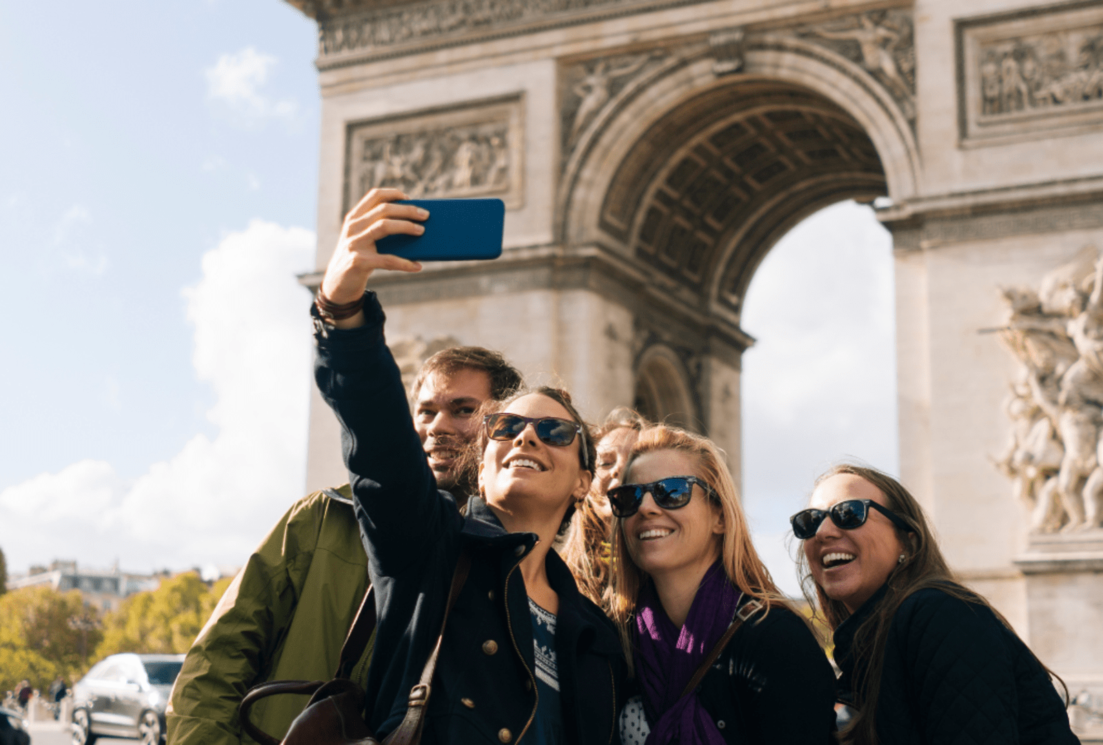 A group of friends pose for a selfie by the Arc de Triomphe