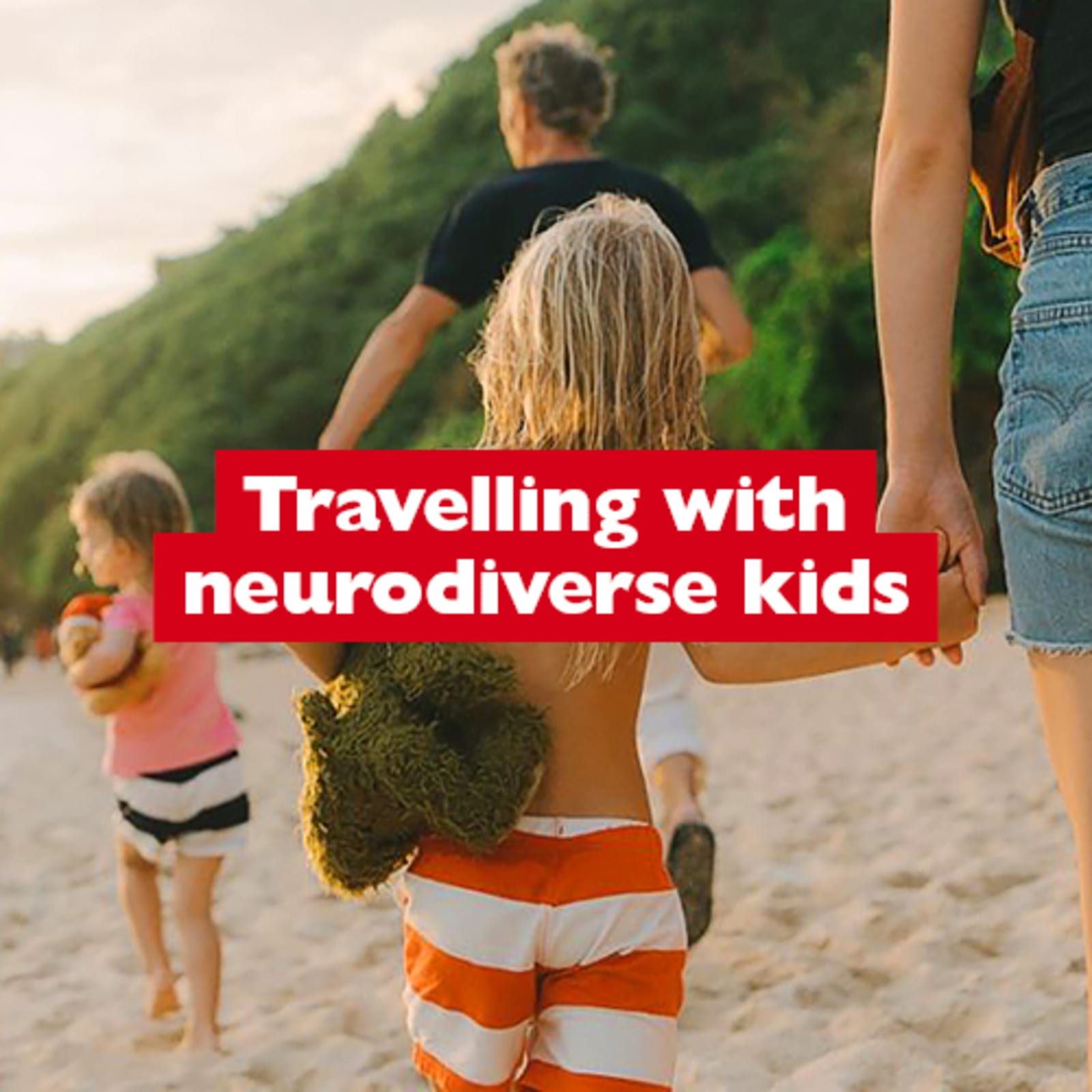 Travelling with neurodiverse kids - family of four walking along a beach in the late afternoon