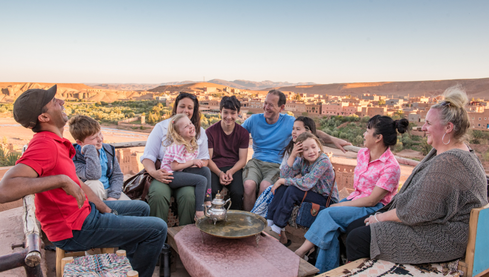 Family sitting on chairs around a table