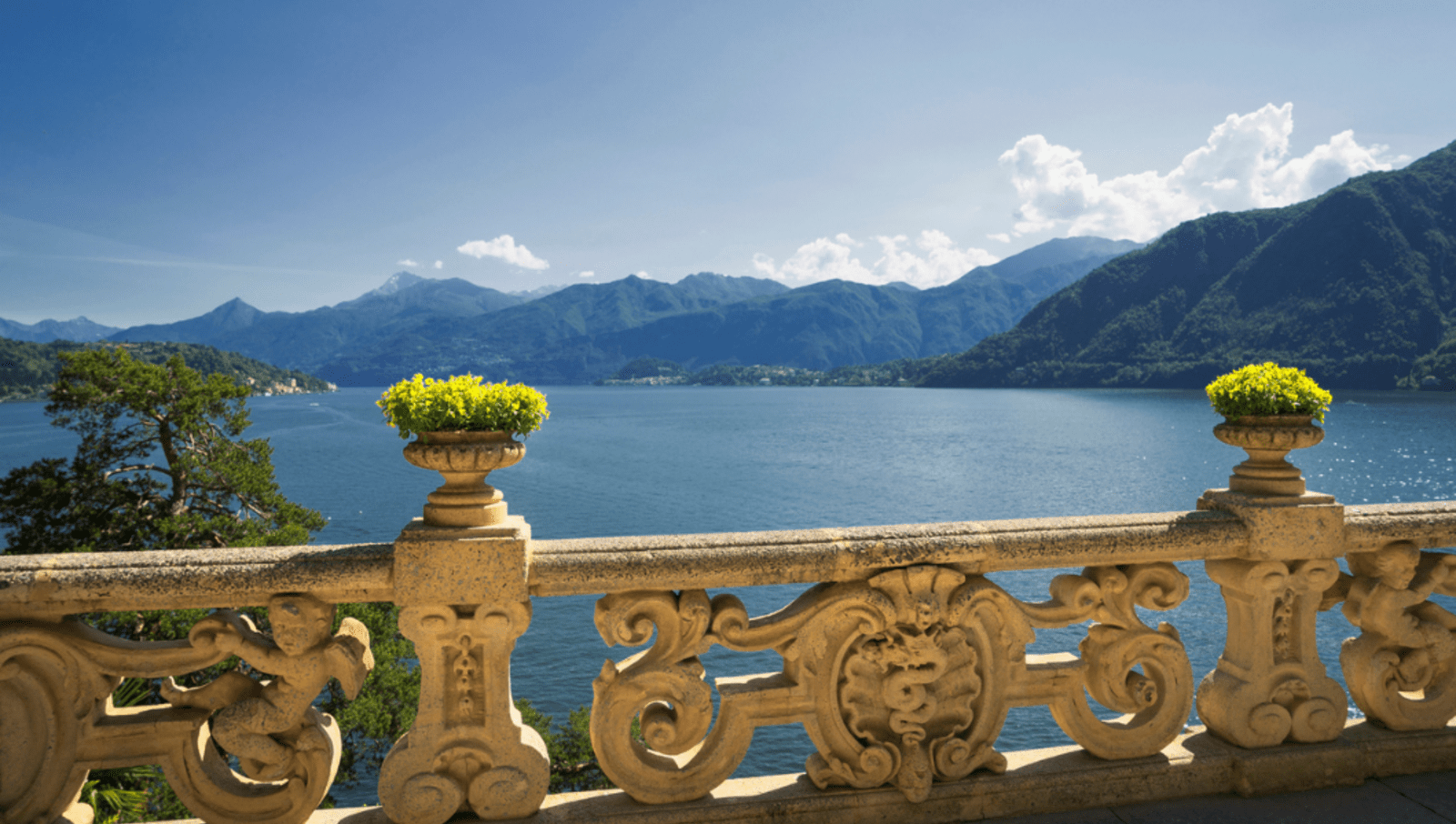 view from ornate balcony of Lake Como with Mountains in background