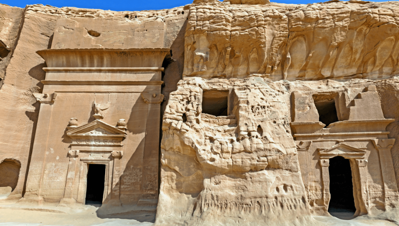 Large beige rocks with carvings of doorways