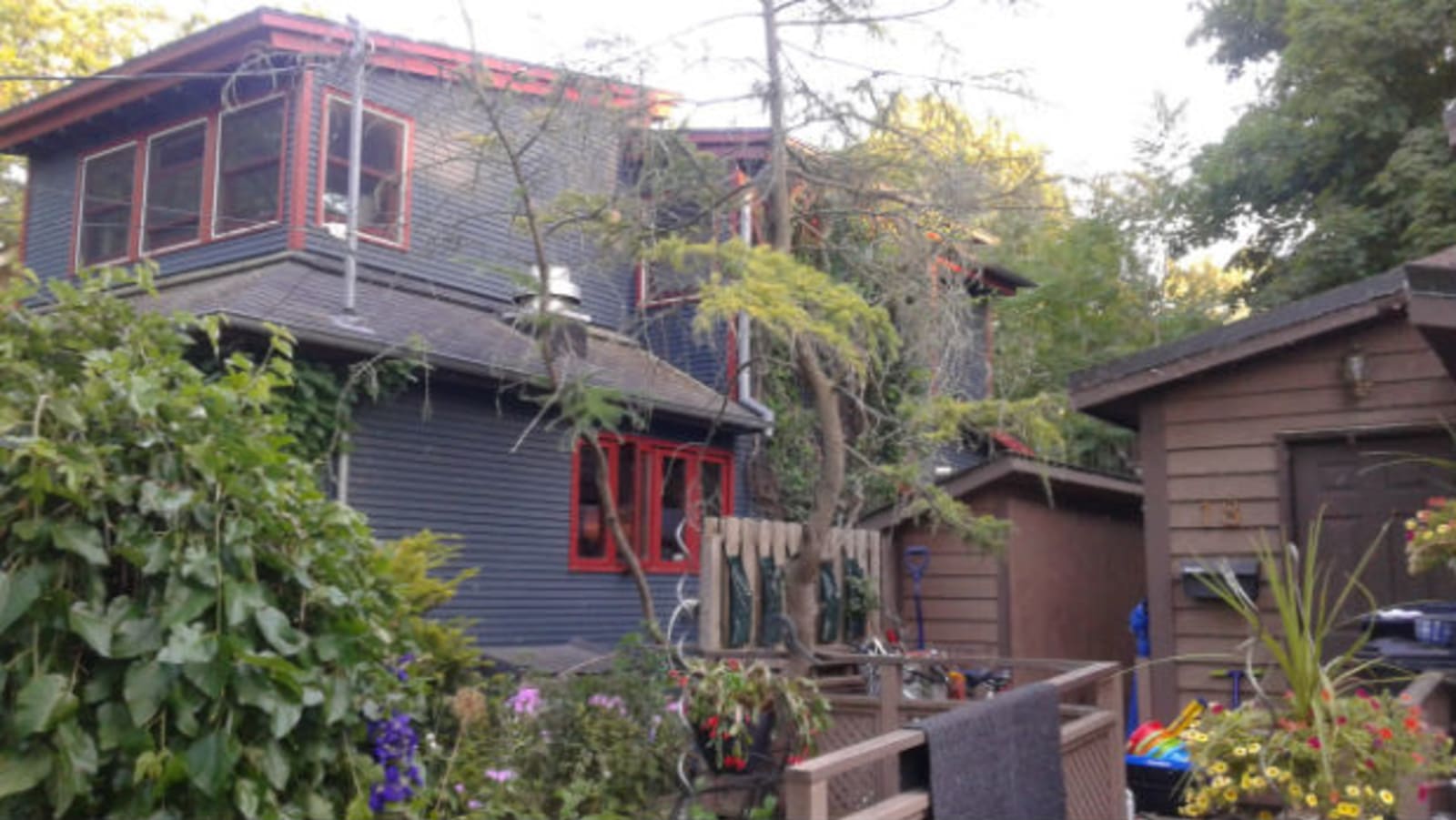 Wards Island House - gunmetal grey two storey house with maroon window frames and gutters