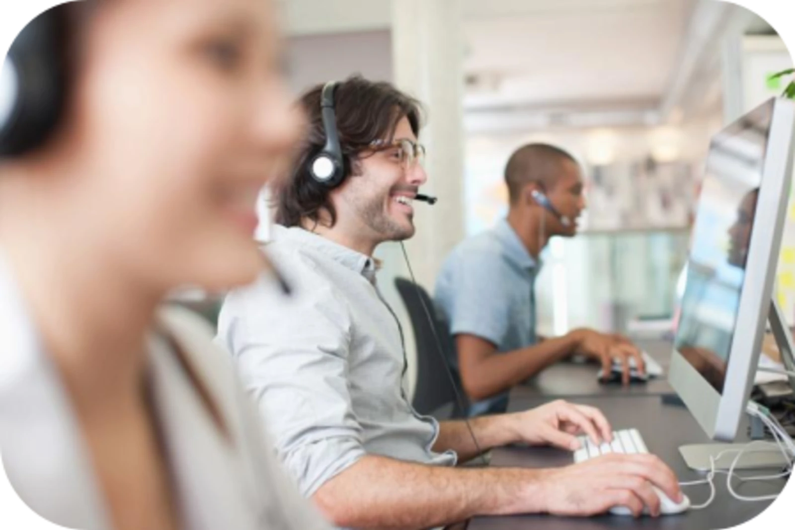 people working in call centre with smiles