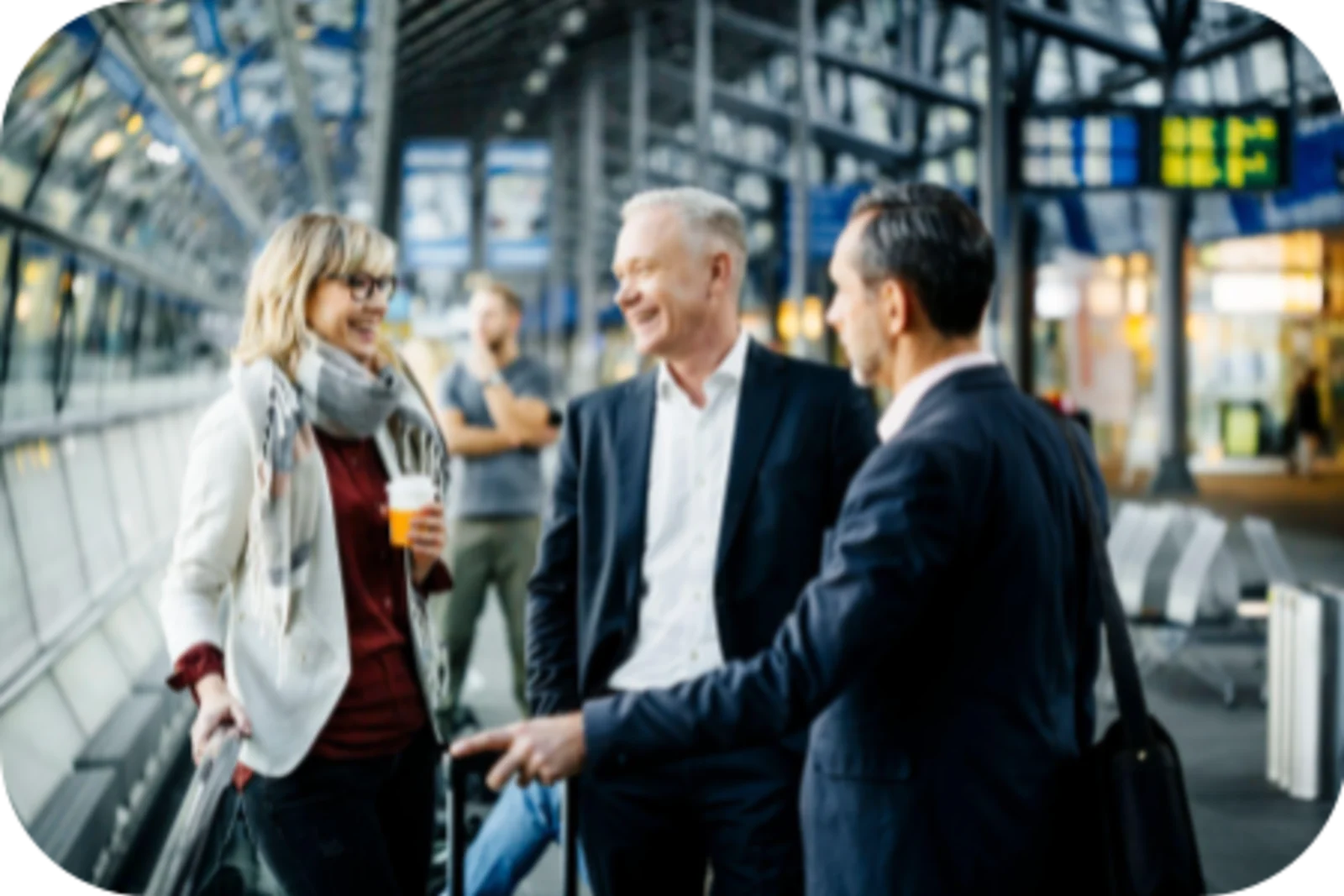 Three people is talking in the airport with big smiles