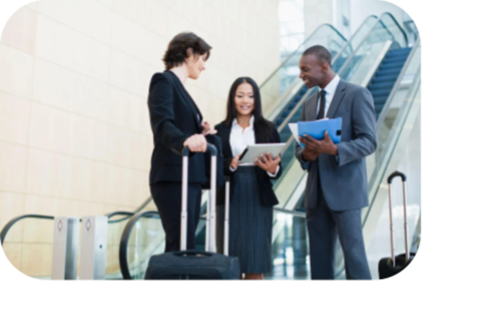 women and man talking in front of escalator