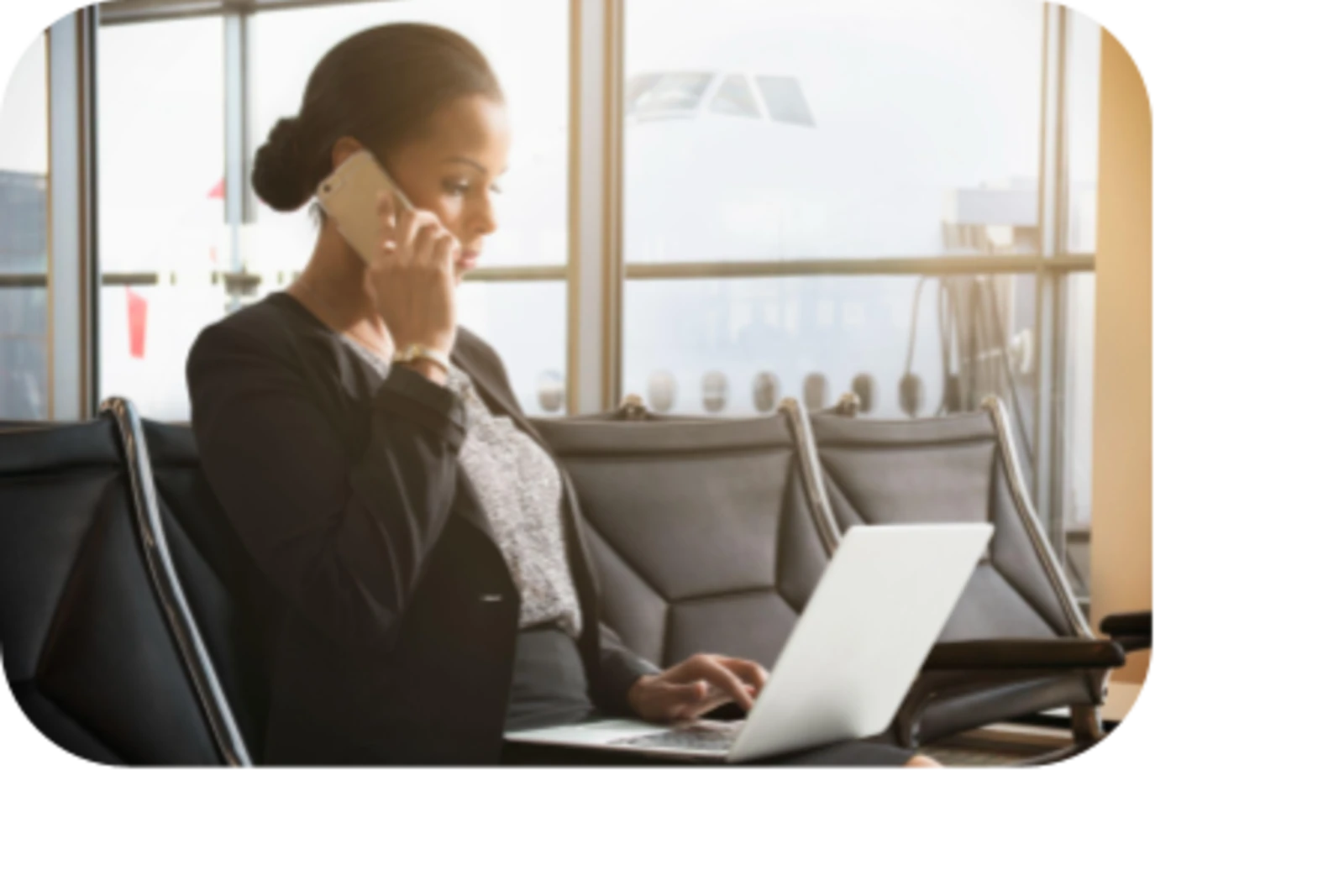 woman talking in phone and using laptop at airport