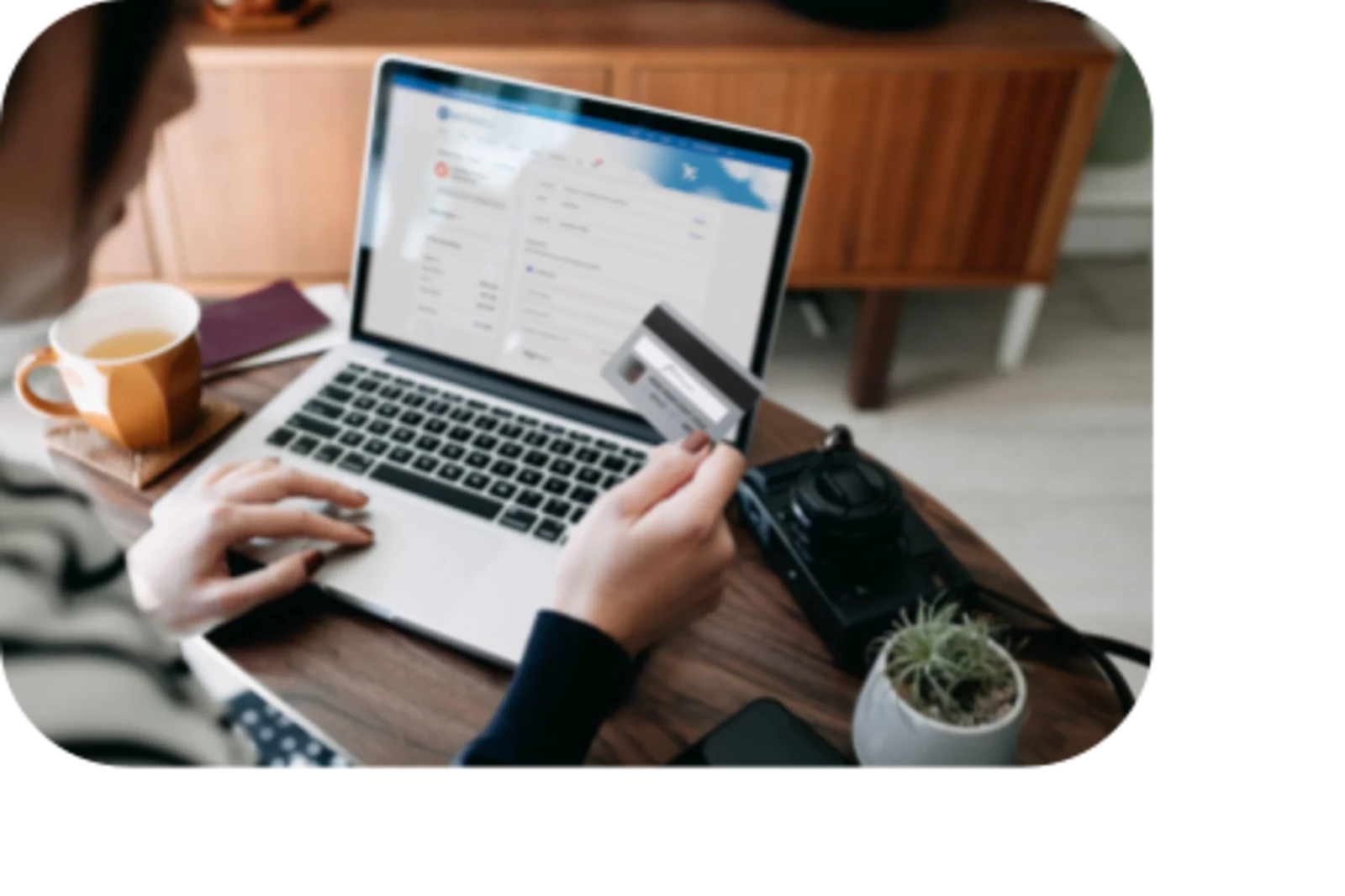 woman typing credit card information to laptop