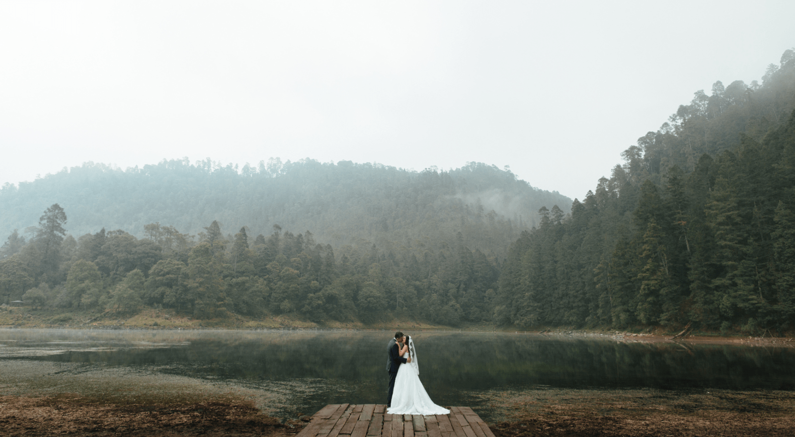 couple kissing by lake