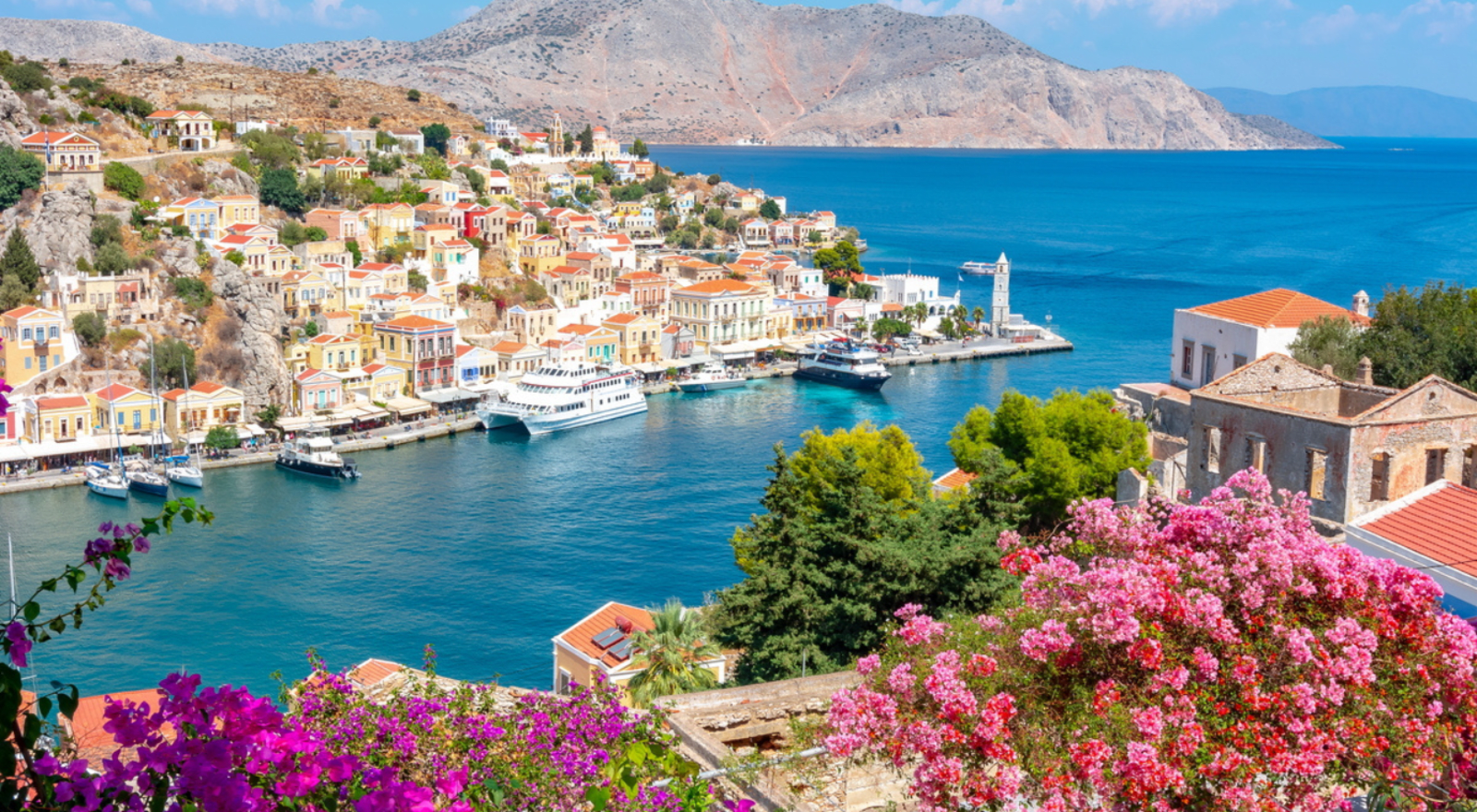 Coastline of greece with blue water and stone buildings