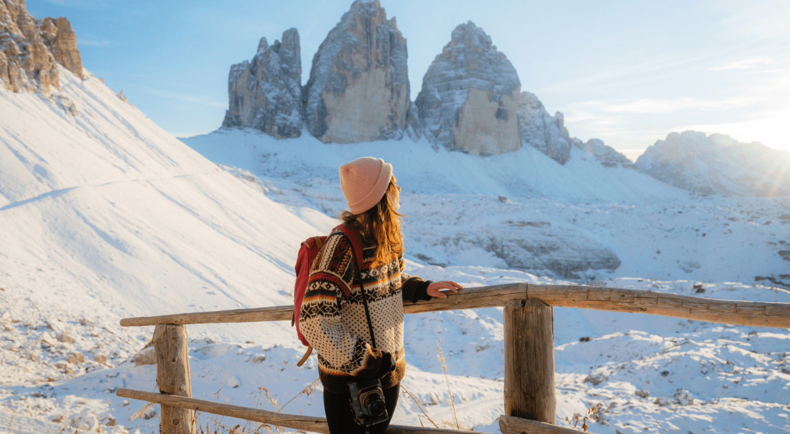 Lady looking out at snowy mountains