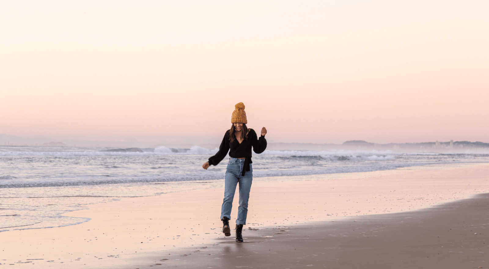 lady on beach in winter at sunset