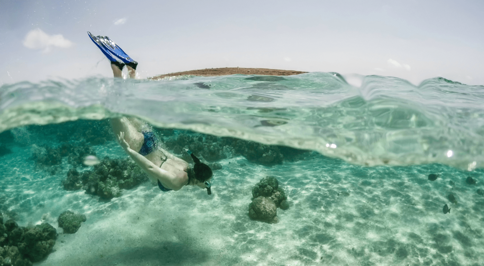 lady diving underwater with snorkel and goggles