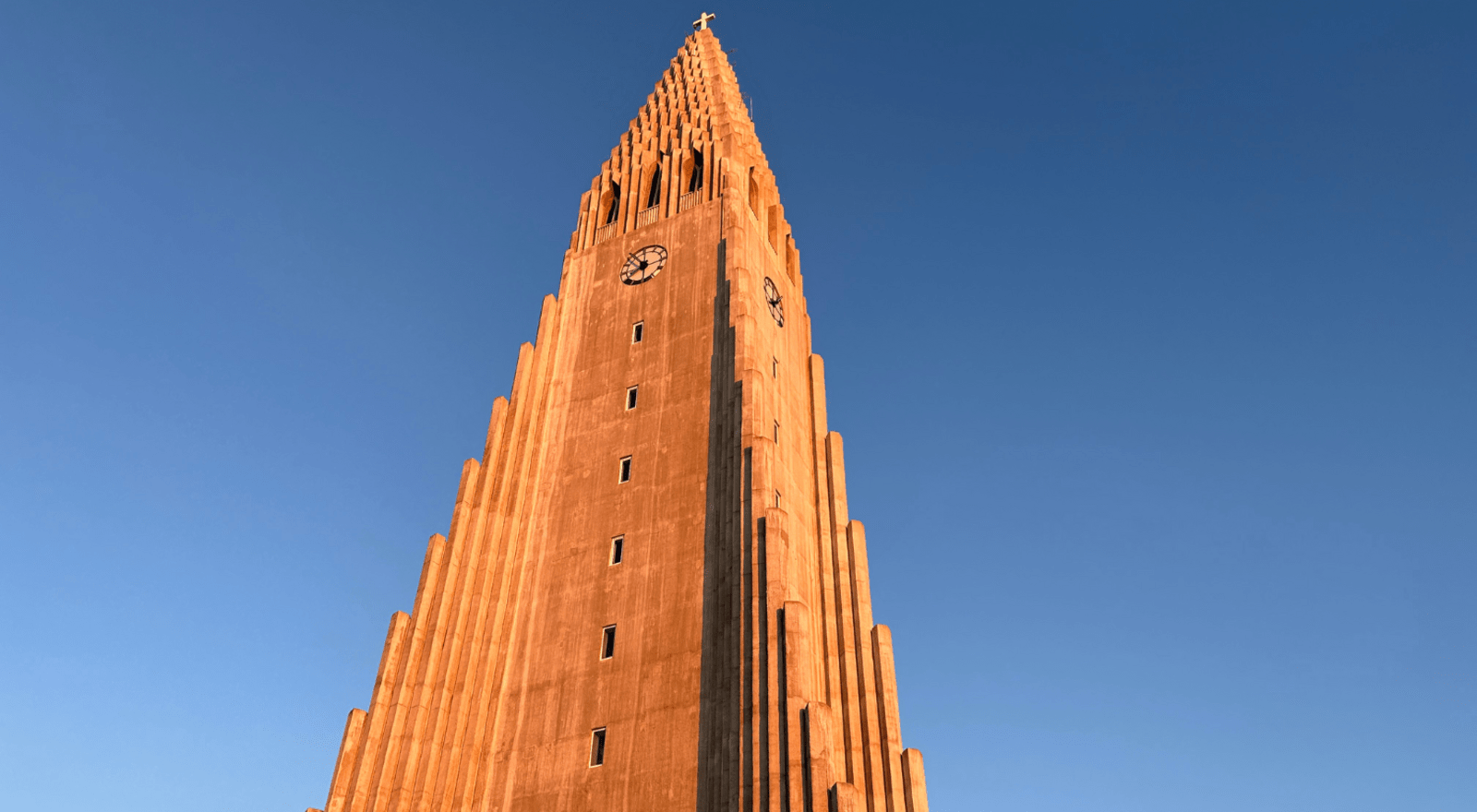 Hallgrímskirkja church in Reykjavík at sunrise against a blue sky