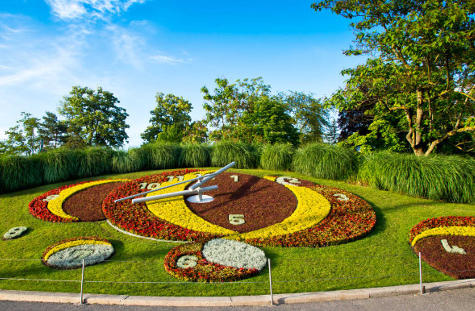 Flower clock in Switzerland, multiple colors of flowers with grass surrounding it