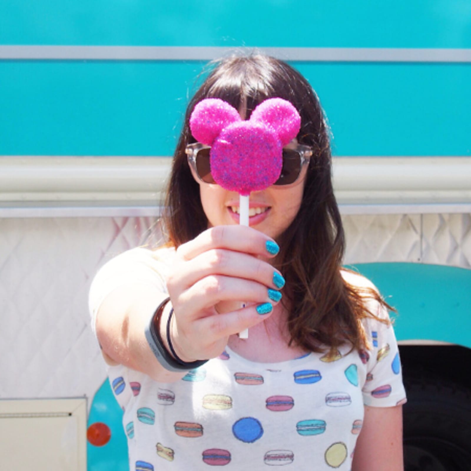 Lady holding a Cakepop in Mickey mouse design
