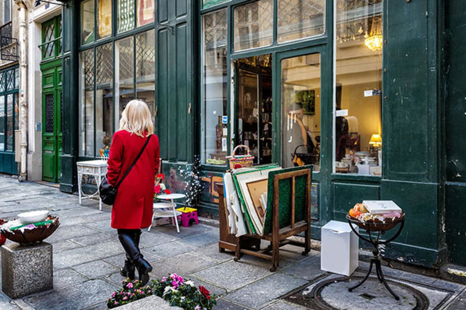 Woman in red coat shopping on the streets of Le Marais