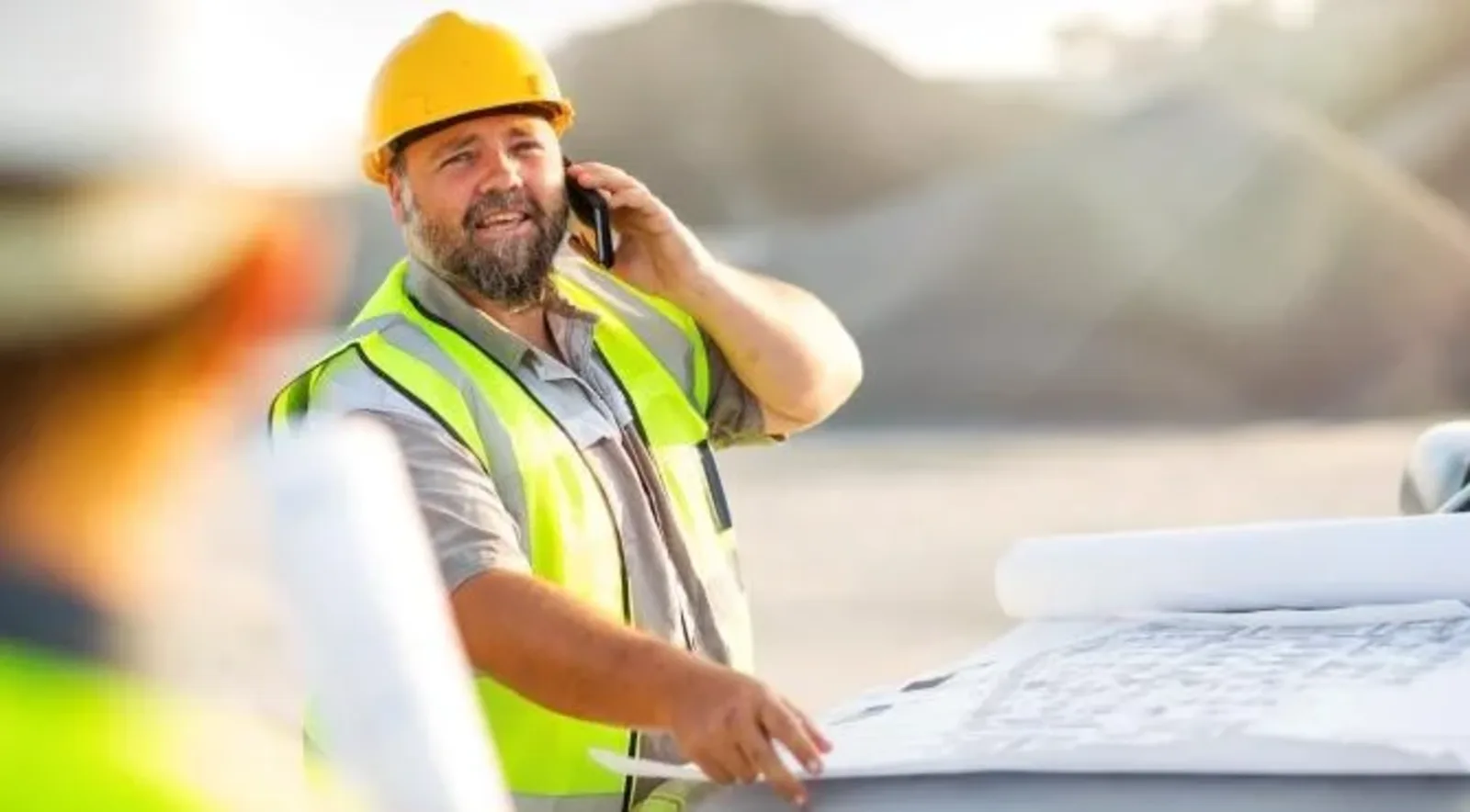 contruction worker talking with client