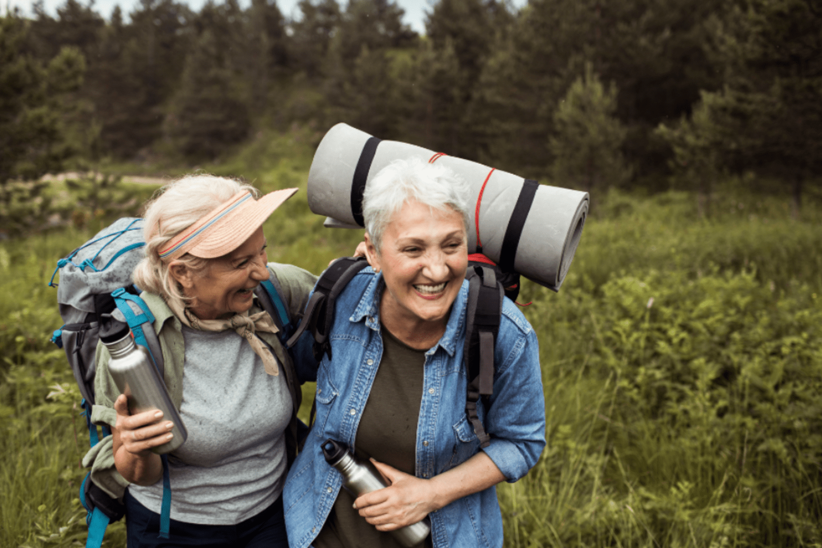 A same-sex couple hiking through a valley