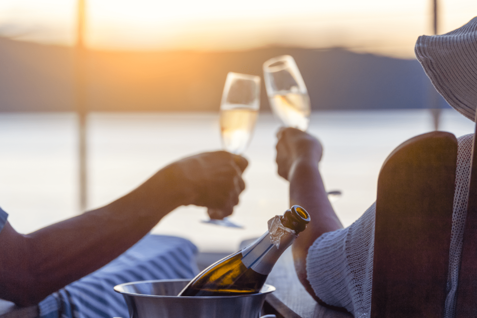 A couple drinking champagne on their cruise ship stateroom balcony