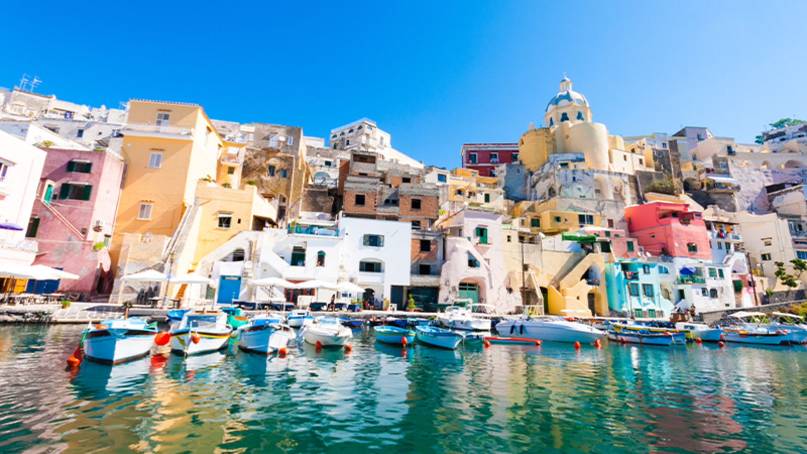 Waterside view of the smooth, vibrant buildings of Naples