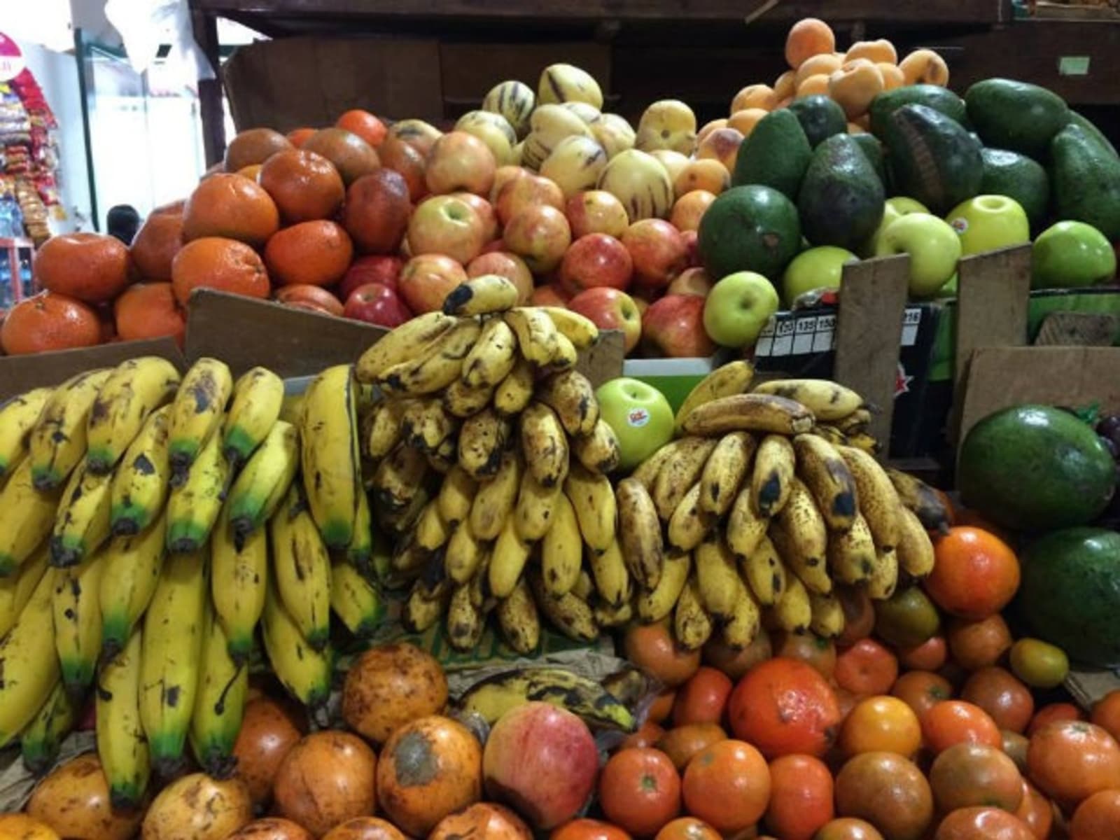 Food market filled with bananas, apples and limes