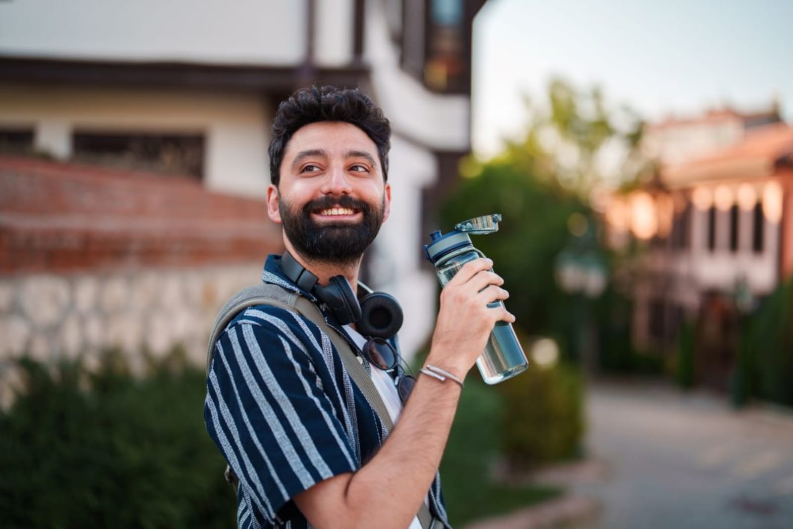 Traveller drinking water from reusable bottle